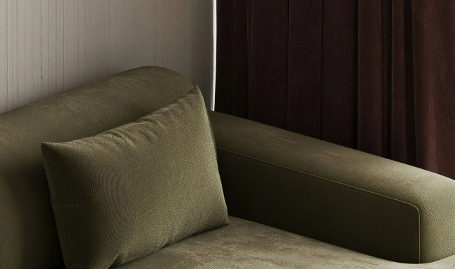 a green couch with pillows